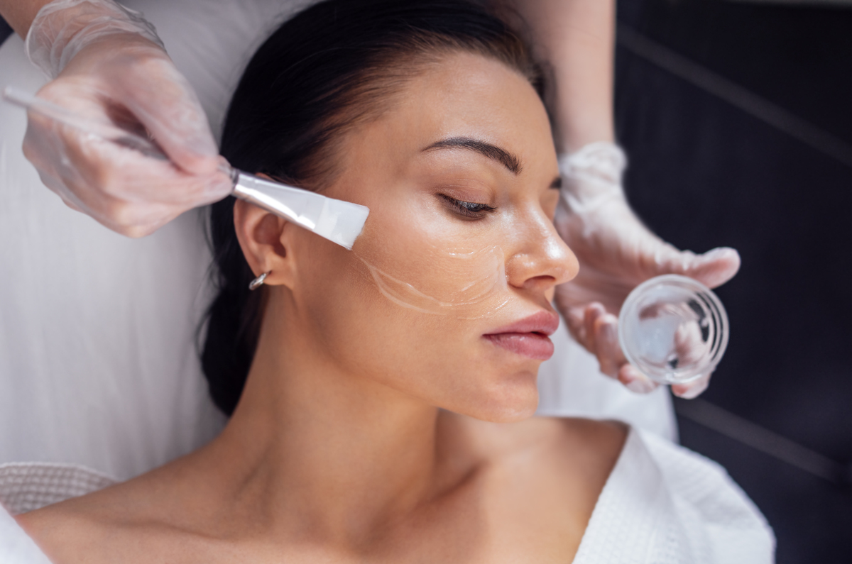 woman getting a clear facial treatment applied
